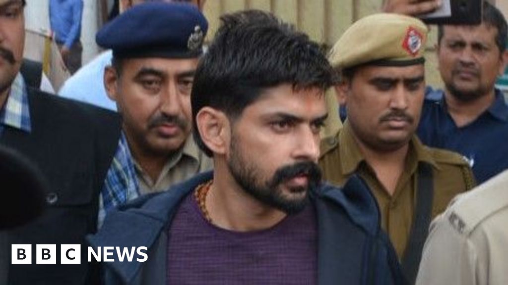 Gangster Lawrence Bishnoi is escorted by police personnel before being produced in court on November 13, 2019 in Panchkula, India. Notorious gangsters Lawrence Bishnoi and Sampat Nehra and their aides were produced in a Panchkula district court amid tight security for framing of charges in two criminal cases that took place in 2017