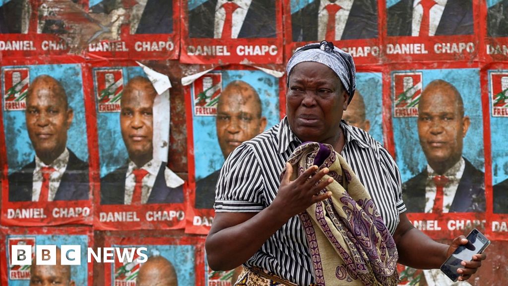 A woman reacts to tear gas in Maputo, Mozambique - Monday 21 October 2024