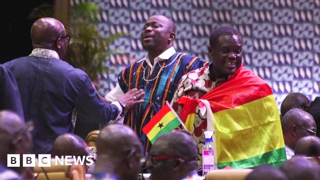 An MP wrapped in a Ghanaian flag stands up in parliament - 22 October 2024